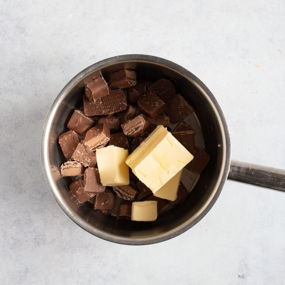 Chopped mars bars and butter in a pan.