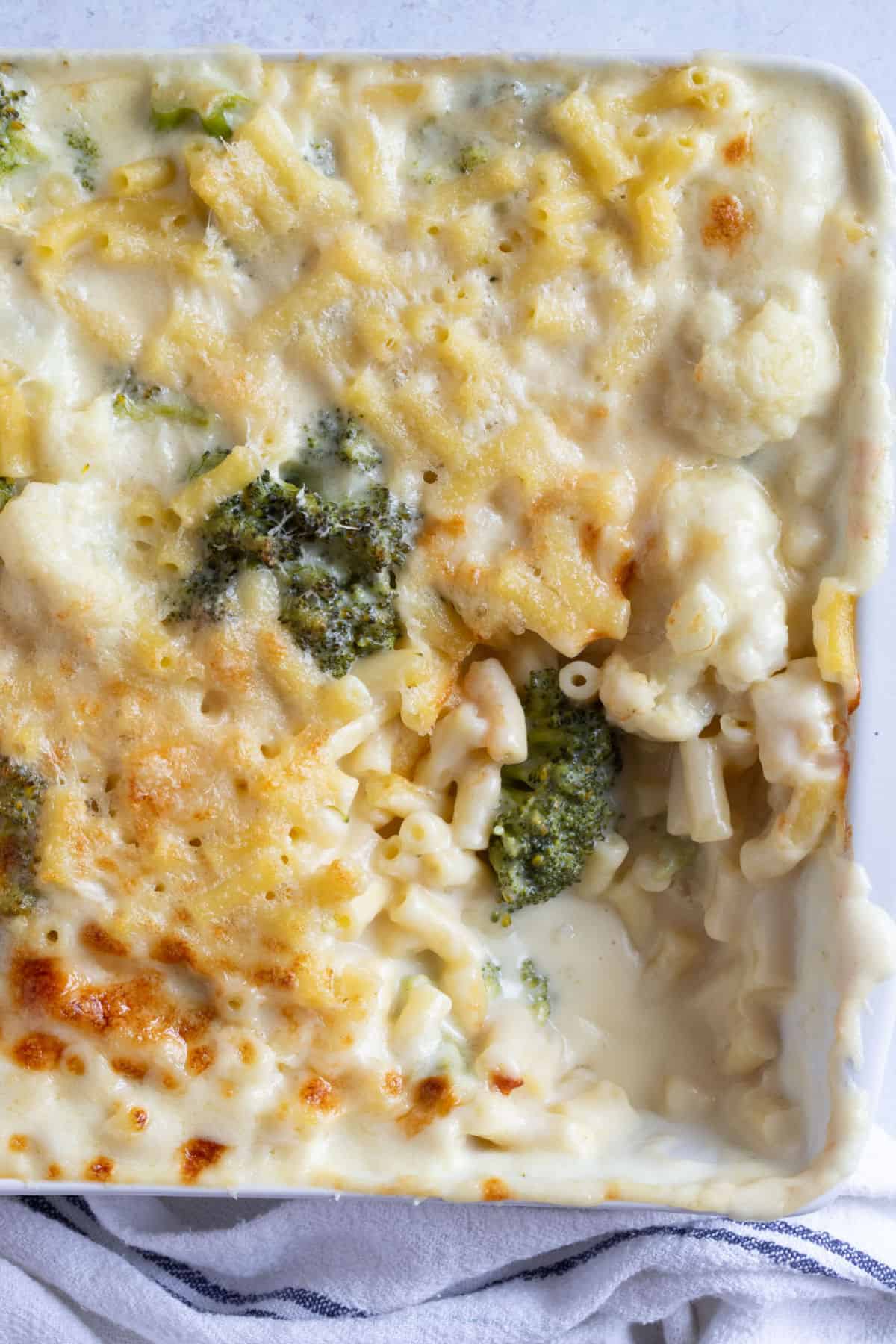Broccoli and cauliflower mac and cheese in a white baking dish.