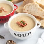 Celeriac and bacon soup in a white bowl.