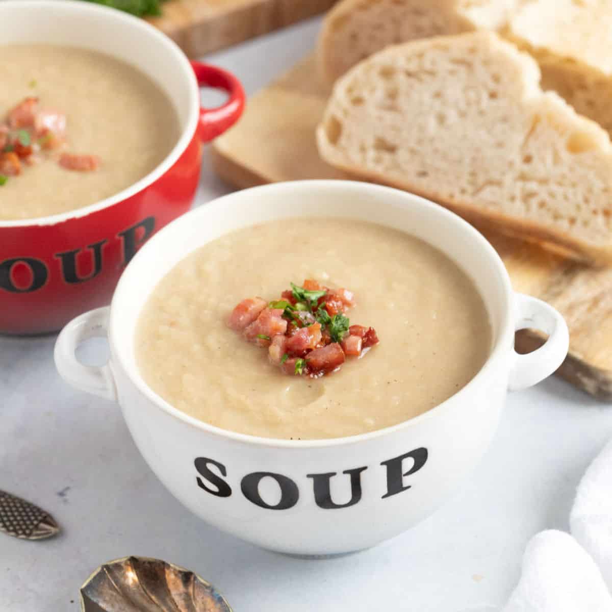 Celeriac and bacon soup in a white bowl.