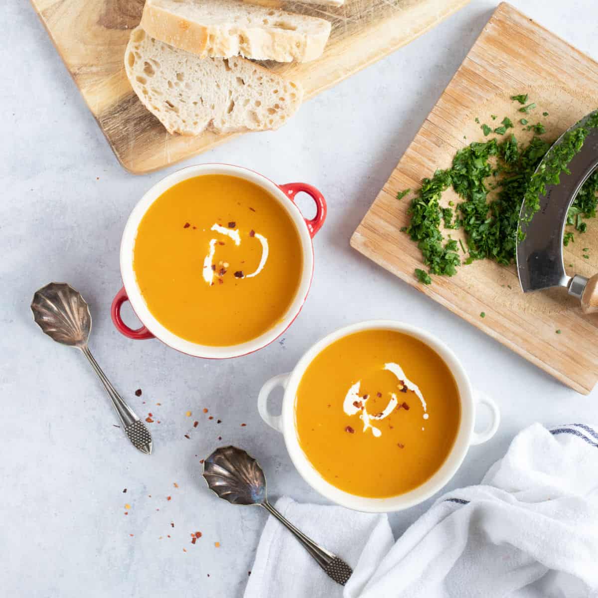 Butternut squash and sweet potato soup in two bowls.