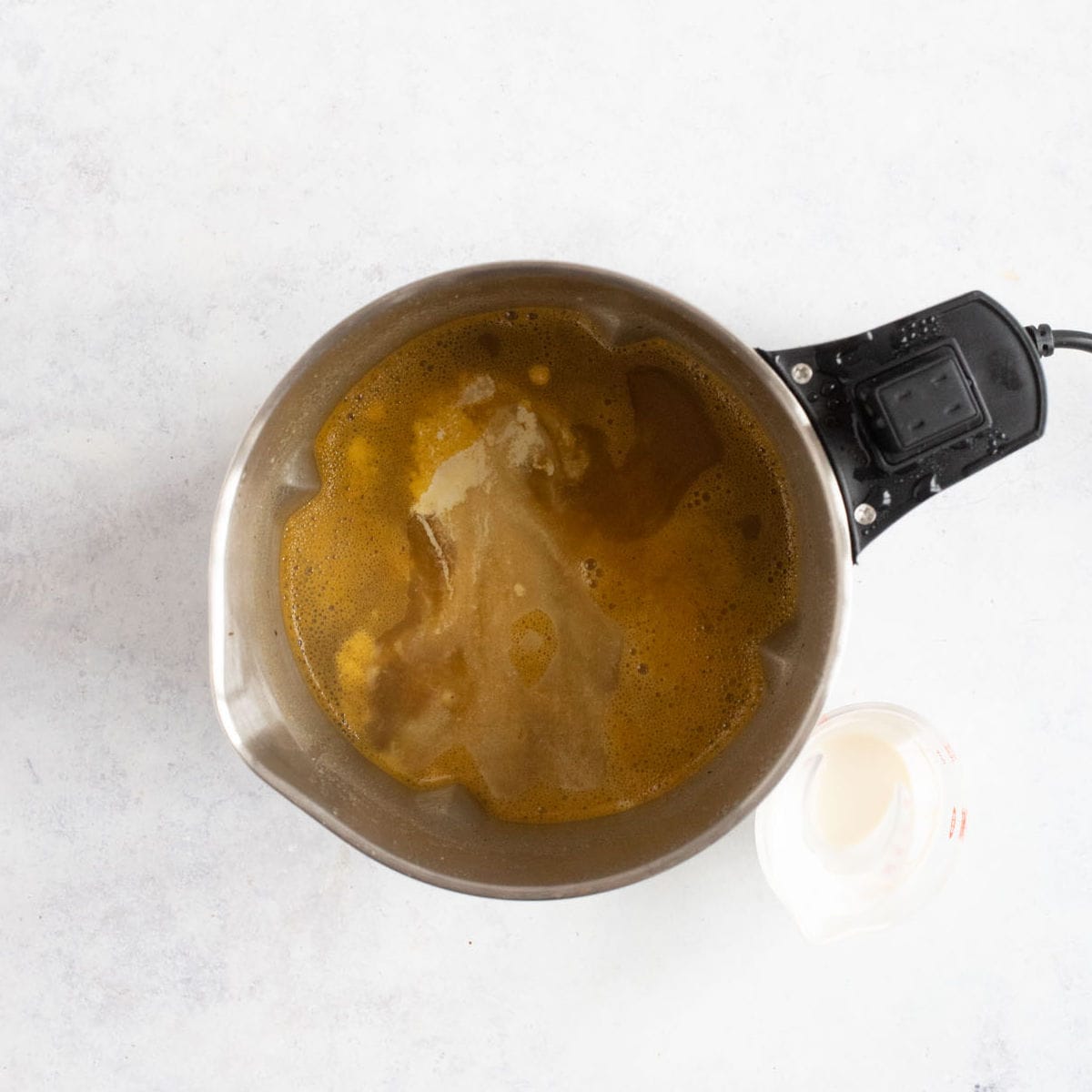 A swirl of double cream into chicken soup in the soup maker.