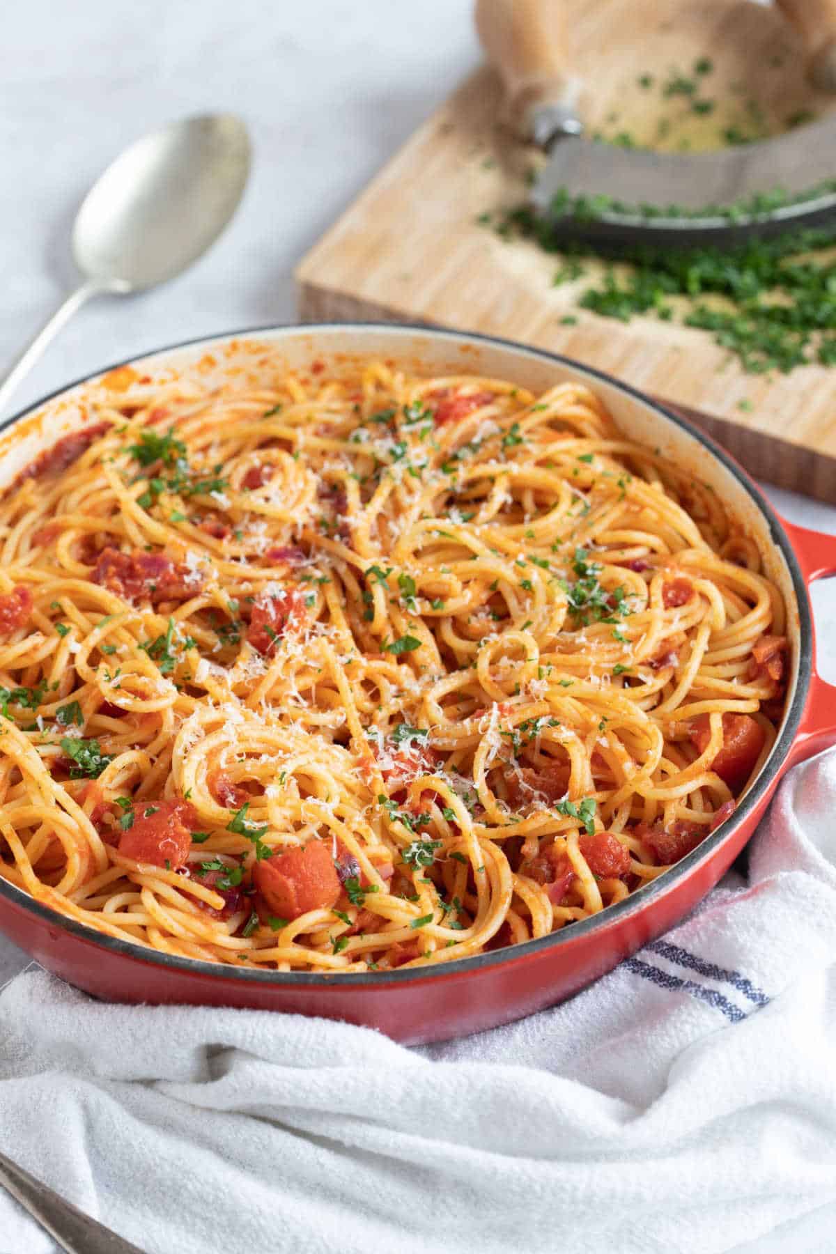 Nduja spaghetti in a red pan.