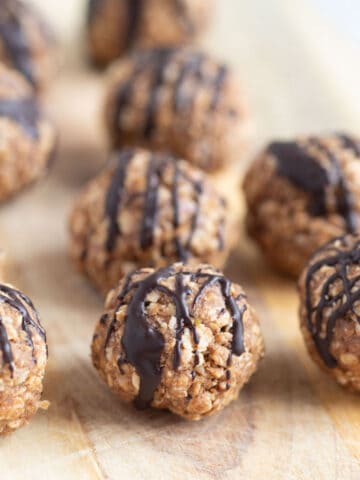 Vanilla protein balls on wooden board.