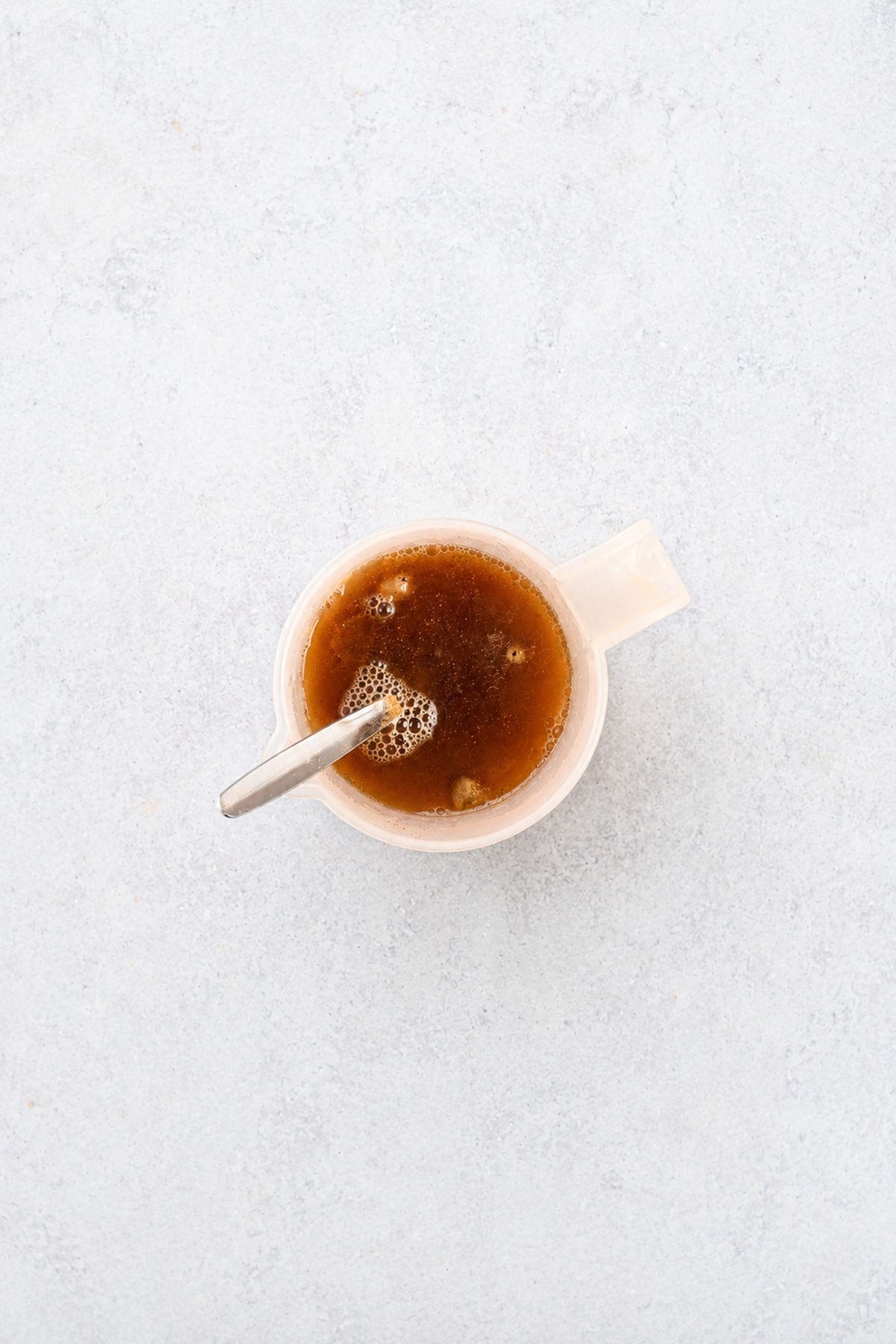 A jug of stock and spices.