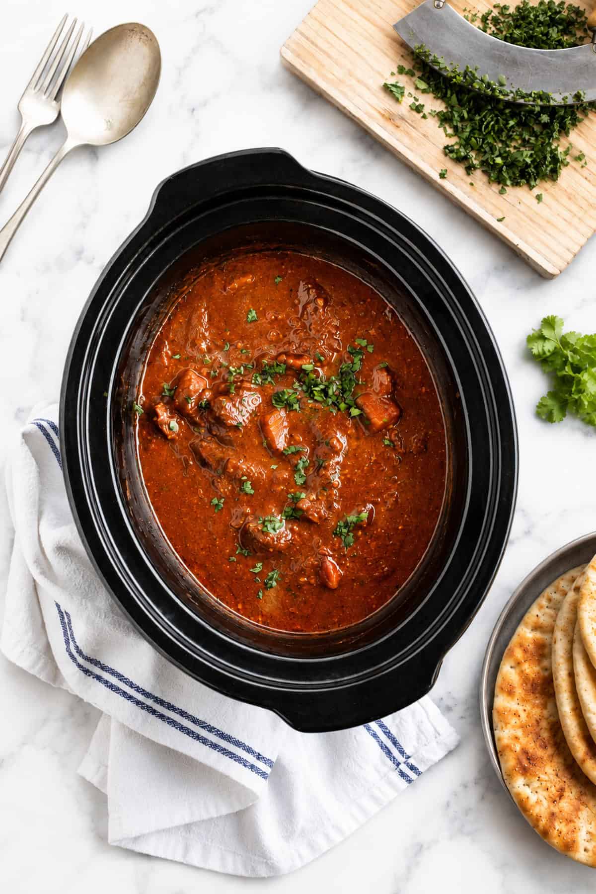 Lamb curry in a black slow cooker.