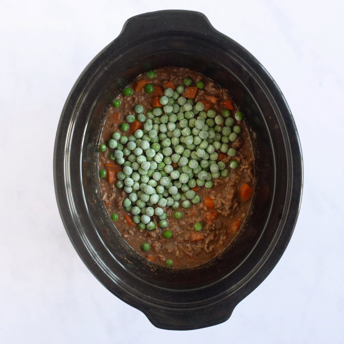 Peas added to the slow cooker mince.