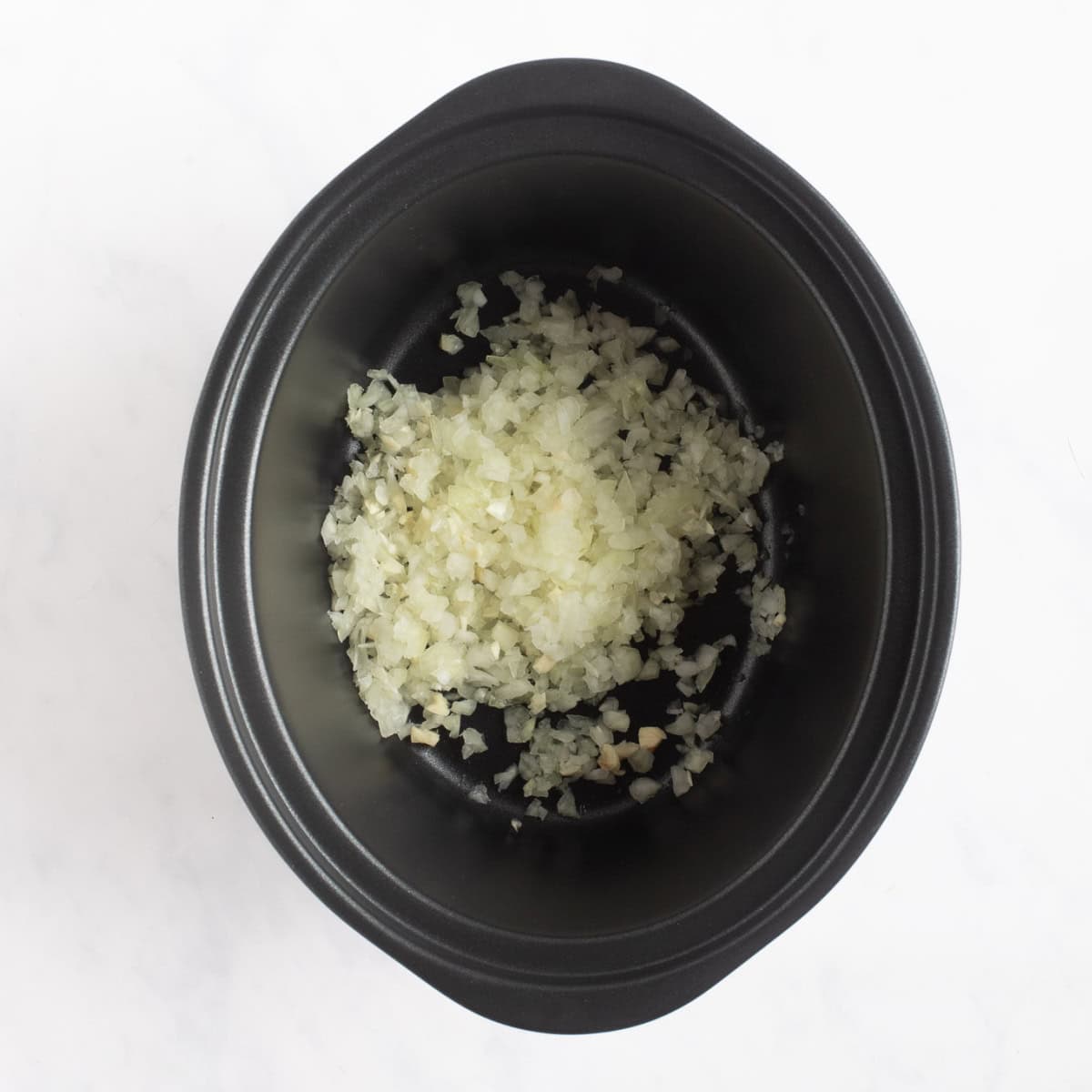 Onion and garlic in slow cooker.