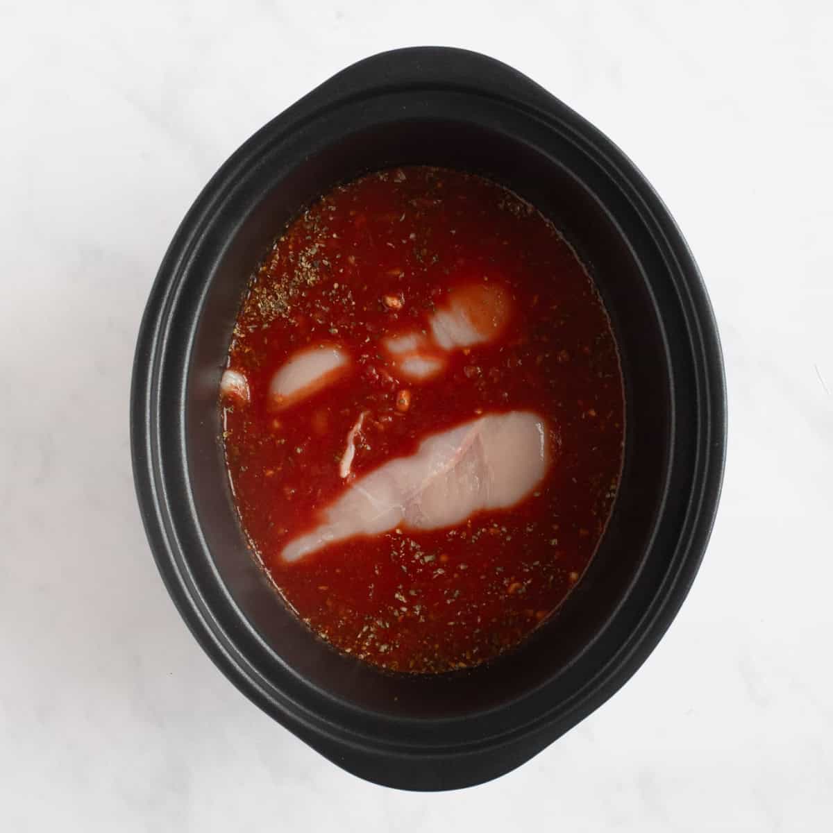 Chicken breasts in the tomato sauce.