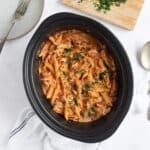 Slow cooker chicken pasta in a black slow cooker.