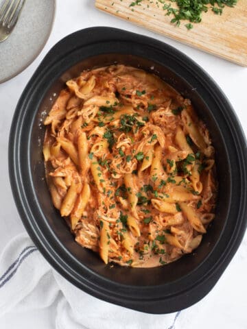 Slow cooker chicken pasta in a black slow cooker.